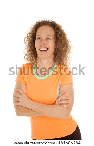 A woman in her fitness clothes with her arms folded and a funny expression on her face.