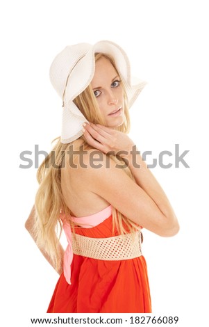 a woman in her red sundress and floppy hat with a sensual expression