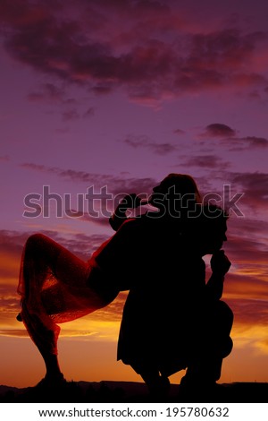 A silhouette of a woman thinking and leaning back on her man\'s back while he is thinking.
