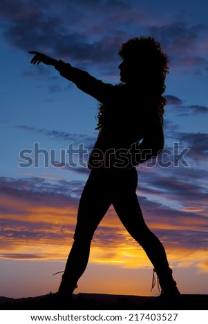 A silhouette of a woman pointing, leaning back.