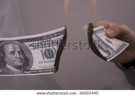 Lighting a one hundred dollar bill on fire