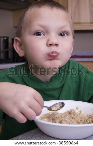 Young boy eating oatmeal for breakfast