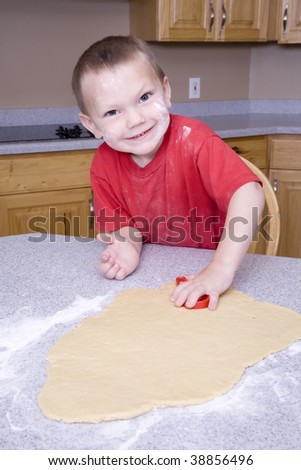 A boy making cut out cookies.