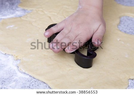 A child making cut out cookies.