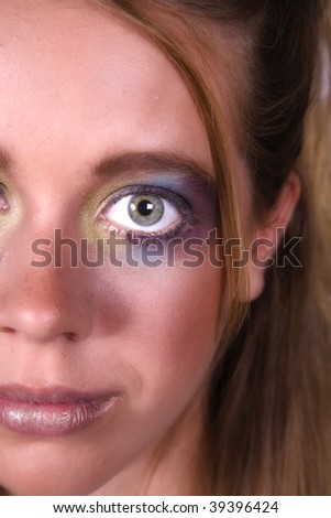 Close up view of half a girls face wearing makeup