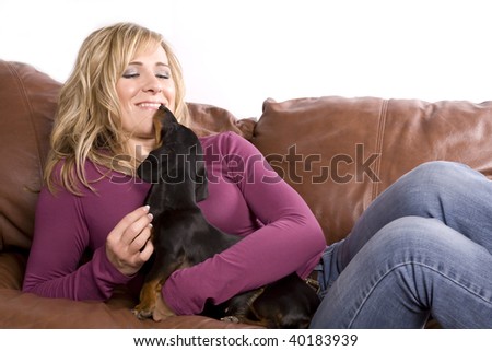A woman looking down at her dog with love in her expression.