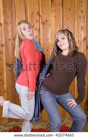 Two teens playing and having fun posing and goofing around.