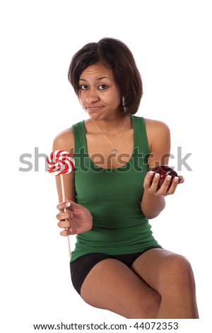 A woman trying to decide on being healthy or not being healthy by eating a red apple or a big red striped sucker.