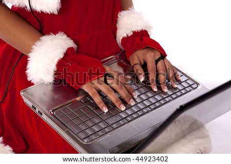 Santa\'s helper with her hands on the computer checking her e-mail.