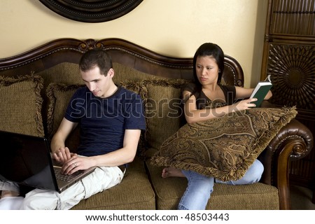 A woman mad at her man because he is spending too much time on the computer and ignoring her.