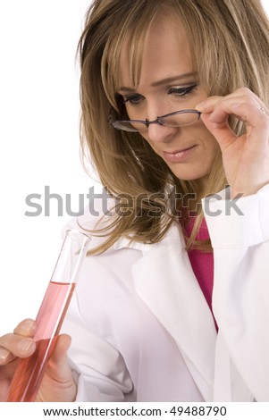 A woman scientist pulling her glasses down to get a better look at the vile.