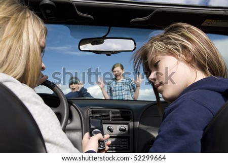 Two teenagers being distracted by a cell phone text, instead of watching the road.  They are about to hit a boy and girl crossing infront of the car.