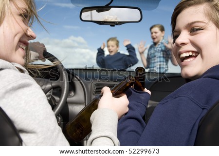 Two teenagers drinking beer and driving a car laughing and not paying attention to the boy and girl that are crossing the street in front of them.  They are about to hit the two kids.