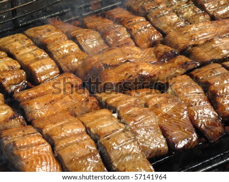 A close up cooking salmon on a outdoor grill to perfection.