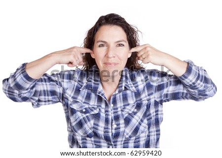 A woman is putting her fingers in her ears.