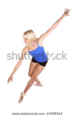 A young woman in her pink point shoes showing her graceful dance pose.