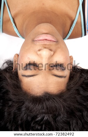 A woman is upside down with her hair fanned out and eyes closed.