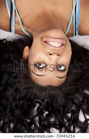 A woman is upside down with her hair fanned out.
