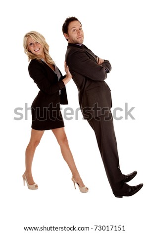 A business woman holding up her business man while he lays back on her hands.