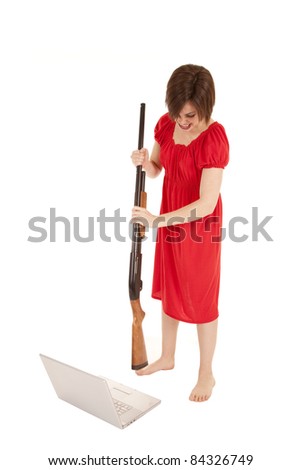 A woman angry at her computer getting ready to slam it with a gun.