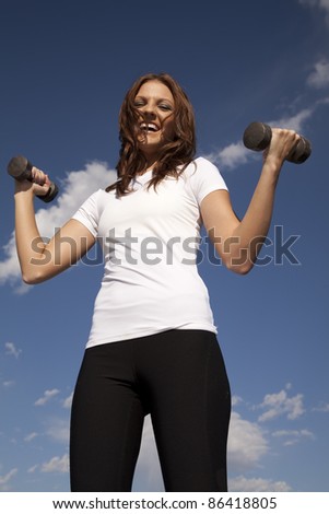 A woman laughing and having some fun while she works out.