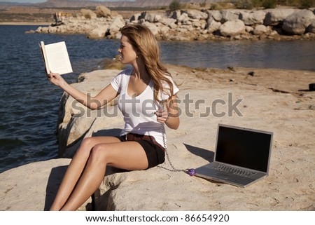 A woman trying to enjoy her book in the outdoors still being locked to work or school through her computer.