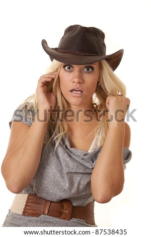 A woman sitting in her gray dress with  a western hat with a shocked expression on her face.