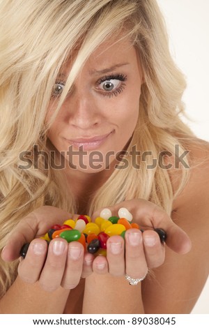 a woman looking at all the colorful jelly beans she gets to eat.