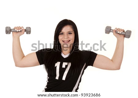 a teen girl lifting weights and showing off her muscles.