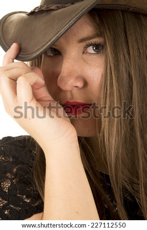 A woman with her brim of her hat pulled down with a sexy expression.