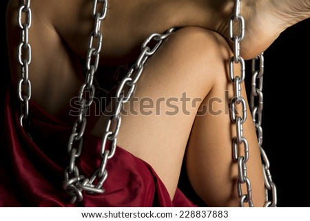 A woman\'s legs with a chain wrapped around them.
