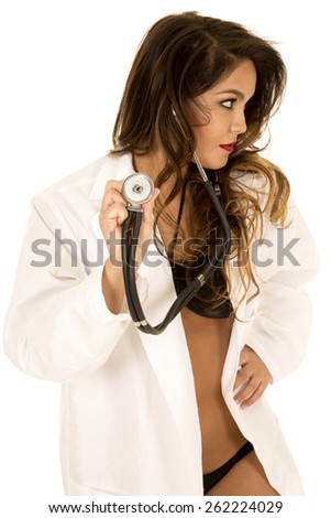 a woman doctor in her lab coat and bikini, holding on to her stethoscope.