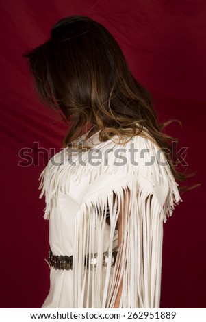 A Native American with her face hidden in her traditional dress.