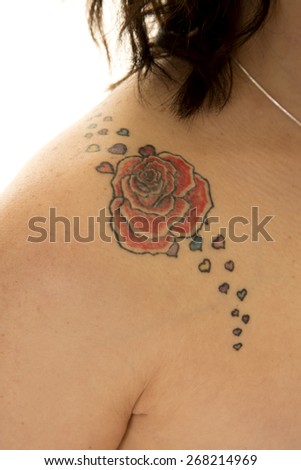 A close up of a rose tattoo on her bare shoulder.