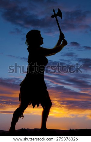 a silhouette of a cave woman with her hatchet up in the air.