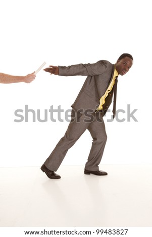 A man\'s arm handing off a baton to a business man who is in a suit and tie.