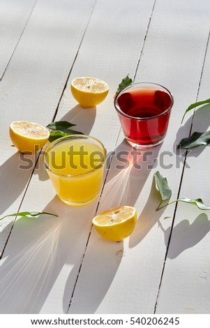 Healthy food & drink & natural diet food: Healthy breakfast. Juice & citrus fruits. Apple orange grapes & cherry juices lemon. Top view White wooden table. Morning sunlight