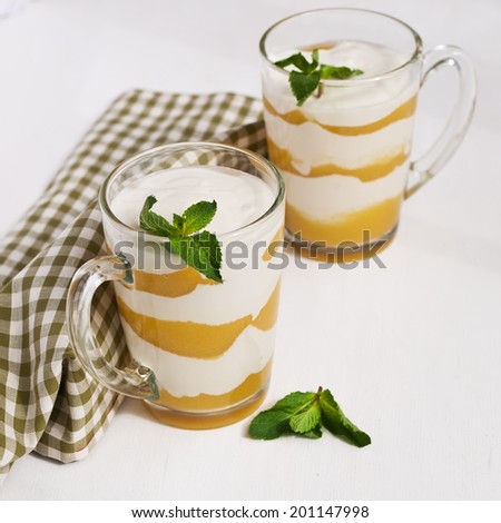 homemade  cream with peach and mint on white