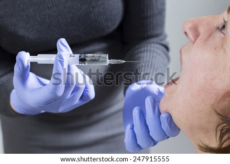 Turkish female dentist is doing vaccine elderly Turkish women