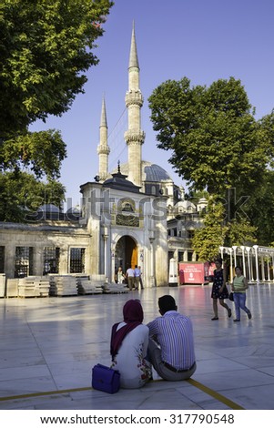 ISTANBUL, TURKEY - JULY 28, 2015: Tourists and Turkish people walking near The Eyup Sultan Mosque, square.The Eyup Sultan Mosque is situated in the district of Eyup in Istanbul. Vertical composition.