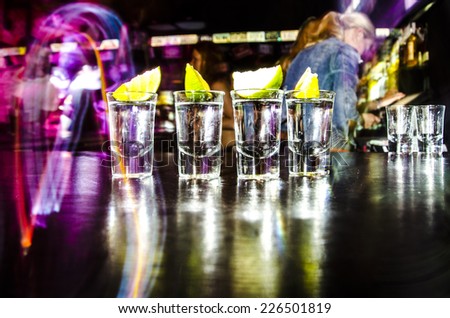 four glasses with Lim on the bar at a nightclub