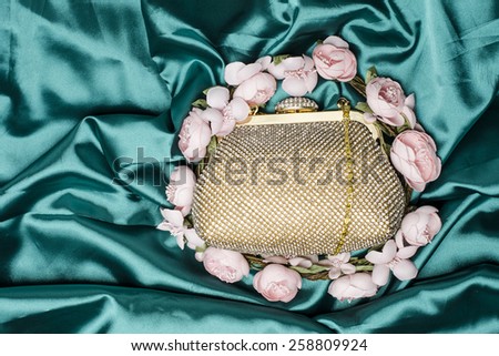 gold clutch in flowers on silk