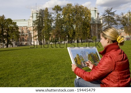Young blond artist drawing queen palace in autumn