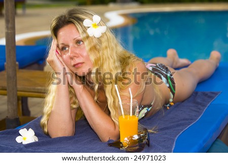 Beautiful blond woman has relax near swimming pool