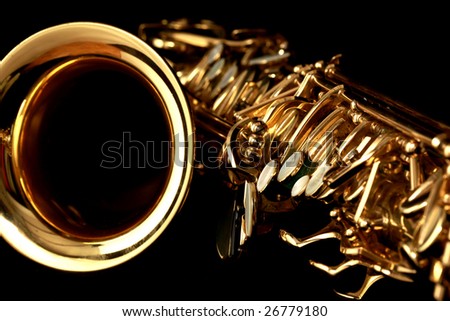 close up gold alto saxophone on black background