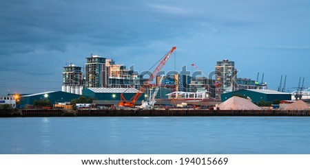 London, UK Ã¢Â?Â? June 9 2011: Mix of industries and residential buildings on bank of Thames in Newham, London.