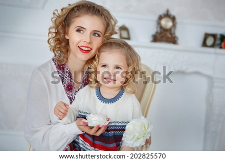 Mom and daughter smiling darzhat flower in hands