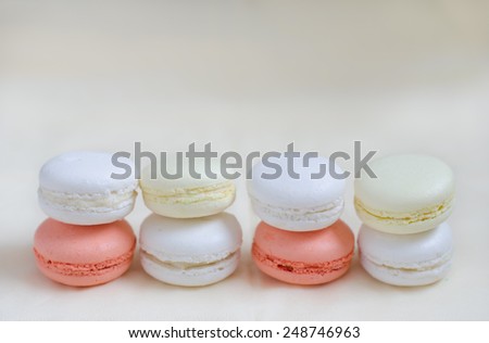 Macarons colored in pastel colors - white, yellow, pink