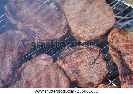 Meat on grill barbecue closeup. Horizontal, view from above