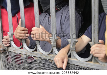 Workers barricaded behind bars for protesting the poor working conditions.